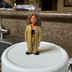 This is a "Huera" figurine from the Homies Series 5 collection.